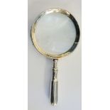 A silver magnifying glass, exaggerated rivets to mount around glass, stepped handle,