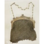 An Edwardian silver mesh purse hung with spherical beads the clasp embossed with Art Nouveau