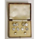 A set of mother of pearl dress studs and cufflinks, 9ct and platinum with seed pearl set centres,