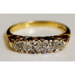 A five stone diamond ring, pavé set with scroll cast shoulder, 14ct yellow gold shank,