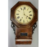 A mid 19th Century walnut veneered Black Forest drop case wall clock the octagonal top enclosing a