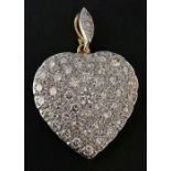 A diamond set gold coloured metal heart with central circular cut larger stone flanked by evenly