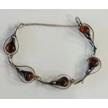 A Nordic silver bracelet of linked bud form each set with an amber coloured stone,