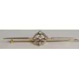 A yellow and white metal bar brooch the circular pierced centre set collet diamond brilliant