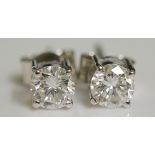 A pair of claw set diamond earring studs, circular brilliants approx. 0.