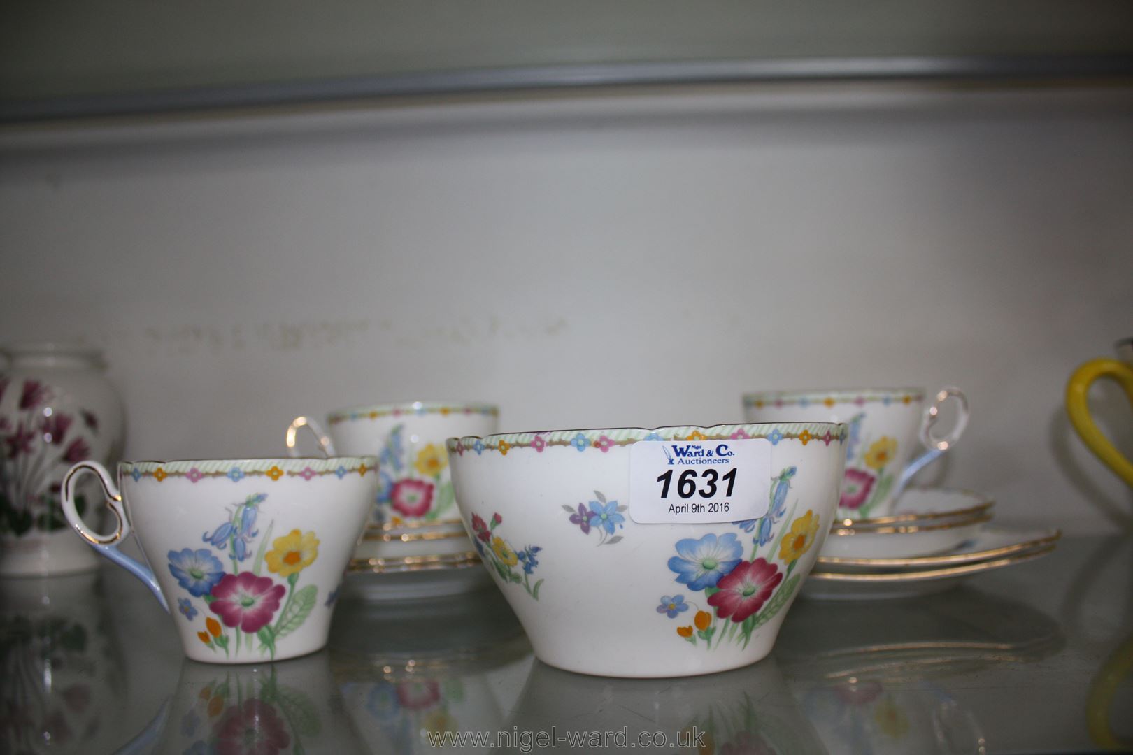 A Shelley first edition part Teaset with wild flower pattern and comprising three cups,