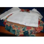 A material bag of large white Tablecloths.