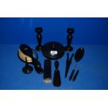 An ebony Dressing Table Set comprising candlesticks, lidded pot, ring stand, mirror, etc.