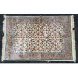 An Ivory ground Cashmere rug with allover floral pattern