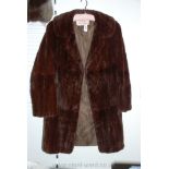 A three quarter length Mink fur Coat by National Fur Company.