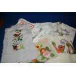 A quantity of Linen and cotton tray or tablecloths mainly embroidered and vintage including three