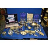 A quantity of plated items including boxed cutlery, christening mug, cruet, glass lined bowls, etc.