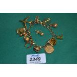 A 9ct Gold Charm Bracelet with twelve charms plus one unattached.