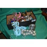 A box of miscellaneous costume jewellery.