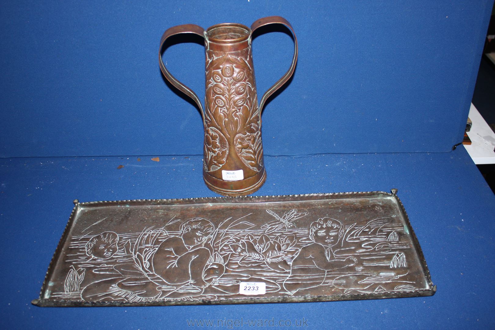 An Arts & Crafts Copper Tray with hammered water babies detail and a two handled repousse Vase