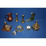 A pair of small brass candlesticks, two miner's ornaments, Welsh horse brass, copper jug,