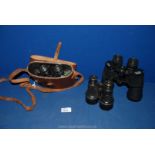 A leather cased pair of Swift Binoculars, 8 x 30, a pair of Dolland Binoculars,