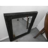 A BLACK CONTEMPORARY WALL MIRROR