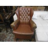 A LEATHER WING BACK CHAIR