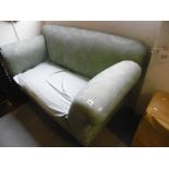 A GREEN UPHOLSTERED SOFA