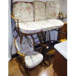 ERCOL SETTEE AND ROCKING CHAIR. Ercol three seater upholstered settee and an upholstered Ercol