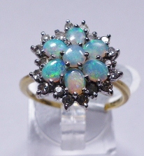 GOLD OPAL AND DIAMOND RING. 18ct yellow gold opal and diamond cluster ring, size R