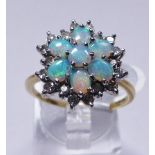 GOLD OPAL AND DIAMOND RING. 18ct yellow gold opal and diamond cluster ring, size R