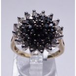 GOLD DIAMOND CLUSTER RING. 9ct yellow gold black and white diamond cluster ring, size O/P