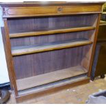 OAK BOOKCASE. Light oak bookcase with glazed doors and carved detail to top, 134 x 138cm