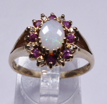 GOLD THREE STONE RING. 9ct yellow gold opal, ruby and diamond ring, size S/T