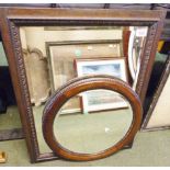 TWO BEVELLED EDGE MIRRORS. Two oak framed bevelled edge mirrors, one rectangular 58 x 75 cm and