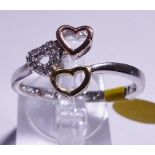 SILVER THREE HEART RING. Sterling silver three heart ring with yellow and rose gold plating, size V