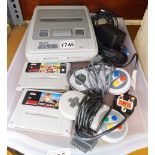 SUPER NINTENDO AND GAMES. Super Nintendo console with two controllers, associated wires and two