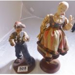 WOODEN FIGURE AND DOLL. Carved wooden figure and a ceramic headed doll, H ~ 24cm