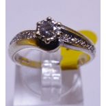 9CT WHITE GOLD DIAMOND SOLITAIRE RING. 9ct white gold diamond solitaire ring with diamond shoulders,