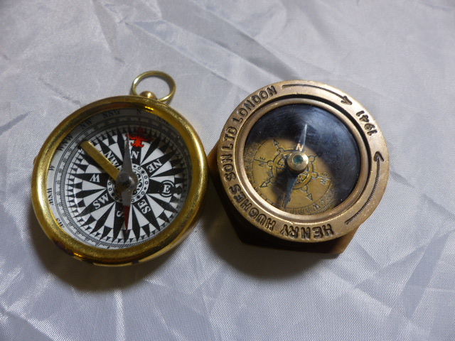 TWO BRASS COMPASSES. Two brass compasses, Henry Hughes