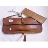 LEATHER TRAVEL POUCHES. Pair of leather travel pouches, one with hair clippers