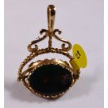 9CT SPINNING FOB. 9ct gold large spinning fob set with onyx, bloodstone and carnelian