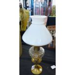 OIL LAMP ON CANDLESTICK. Oil lamp on brass candlestick, H ~ 46cm