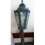 CAST METAL LIGHT. Lead glazed cast metal electric light on wooden supports