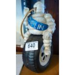 CAST IRON MAN. Cast iron Michelin Man on tyre, H ~ 25cm