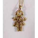 9CT ARTICULATED DOLL. 9ct gold stone set articulated doll on 9ct gold curb necklace