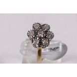 9CT CLUSTER RING. 9ct gold seven stone diamond daisy cluster ring, size J