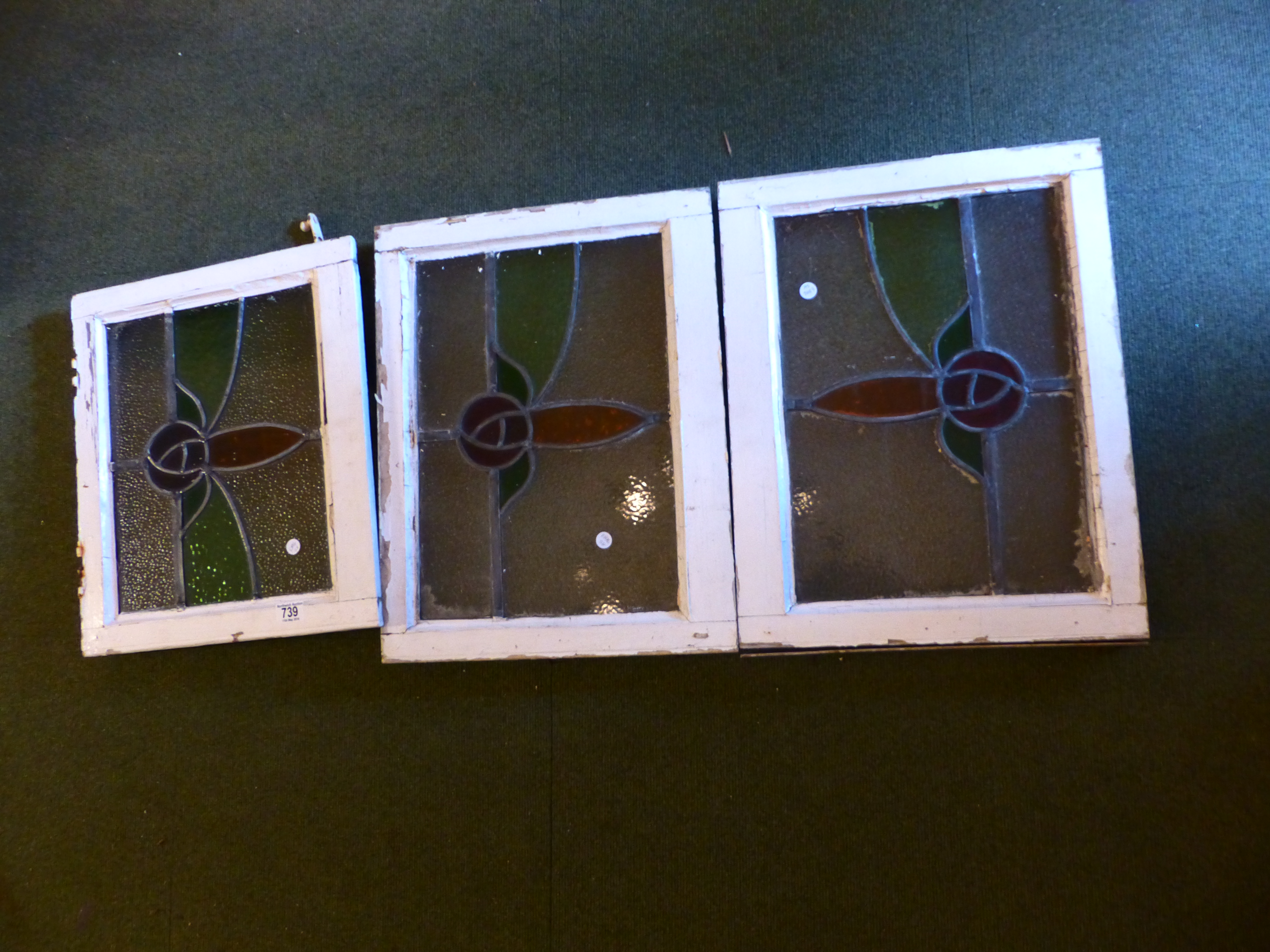 PAINTED GLASS WINDOWS. Three painted framed coloured glass windows
