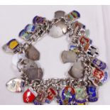 SILVER CHARM BRACELET. Sterling silver charm bracelet full of silver and enamel tabs from towns of