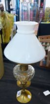 OIL LAMP ON CANDLESTICK. Oil lamp on brass candlestick, H ~ 46cm