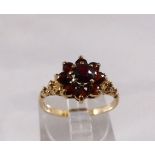 9CT GARNET SET RING. 9ct yellow gold flower garnet set ring