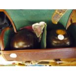 CASED BOWLS. Leather cased set of vintage bowls