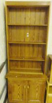 SMALL PINE DRESSER. Pine dresser with shelves with cupboard below, 86 x 215cm