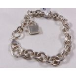 SILVER CHARM BRACELET. Sterling silver solid charm bracelet with modern padlock